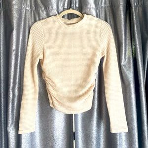 Cream colored long sleeve mesh looking shirt